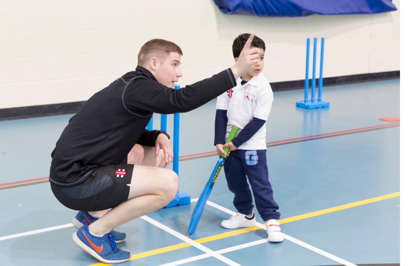 Coach guiding batting grip technique
